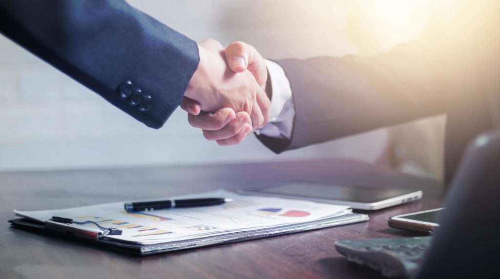 two businessmen shake hands to celebrate a business deal free photo